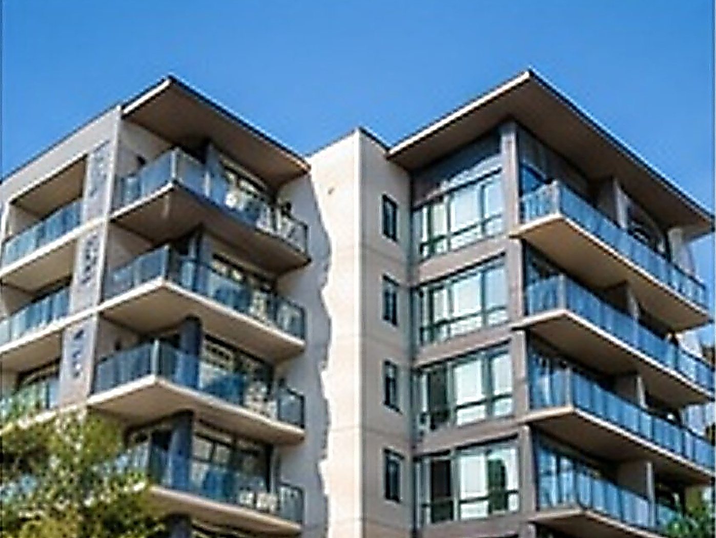 Modern condominium building with glass balconies